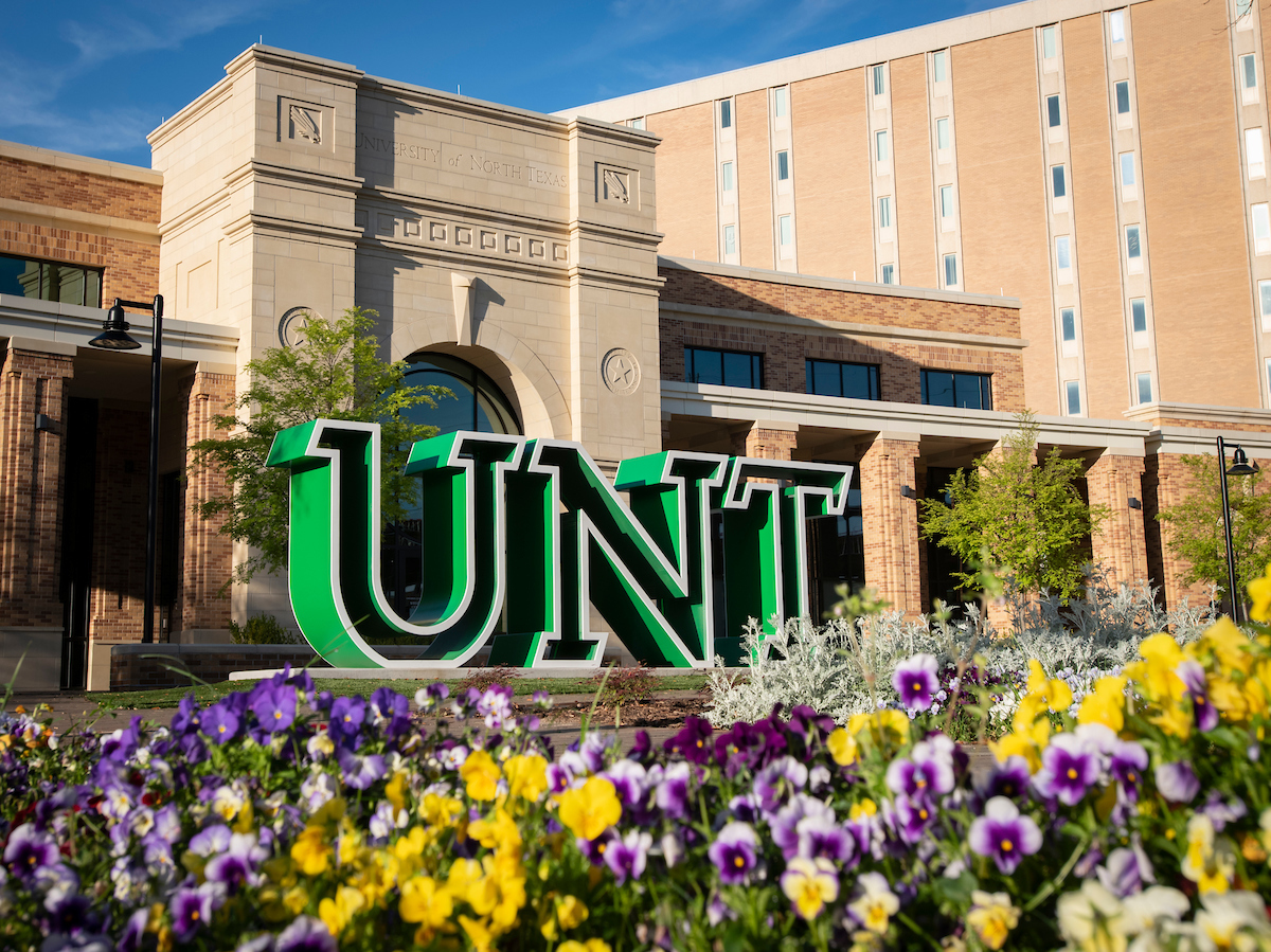 Picture of building with UNT letters and flowers in front