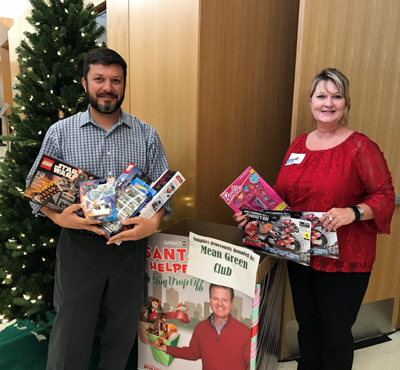 Two Staff Senate officers with toys, Gary Payne, left, and Christi Hestand