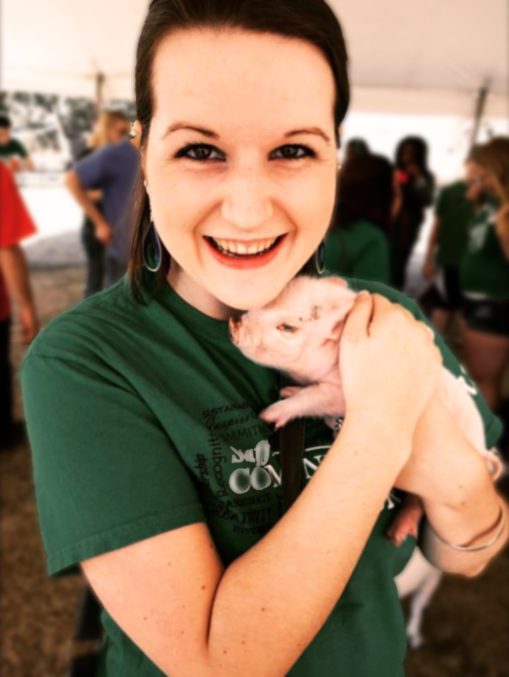 Melissa DeLozier holding a piglet