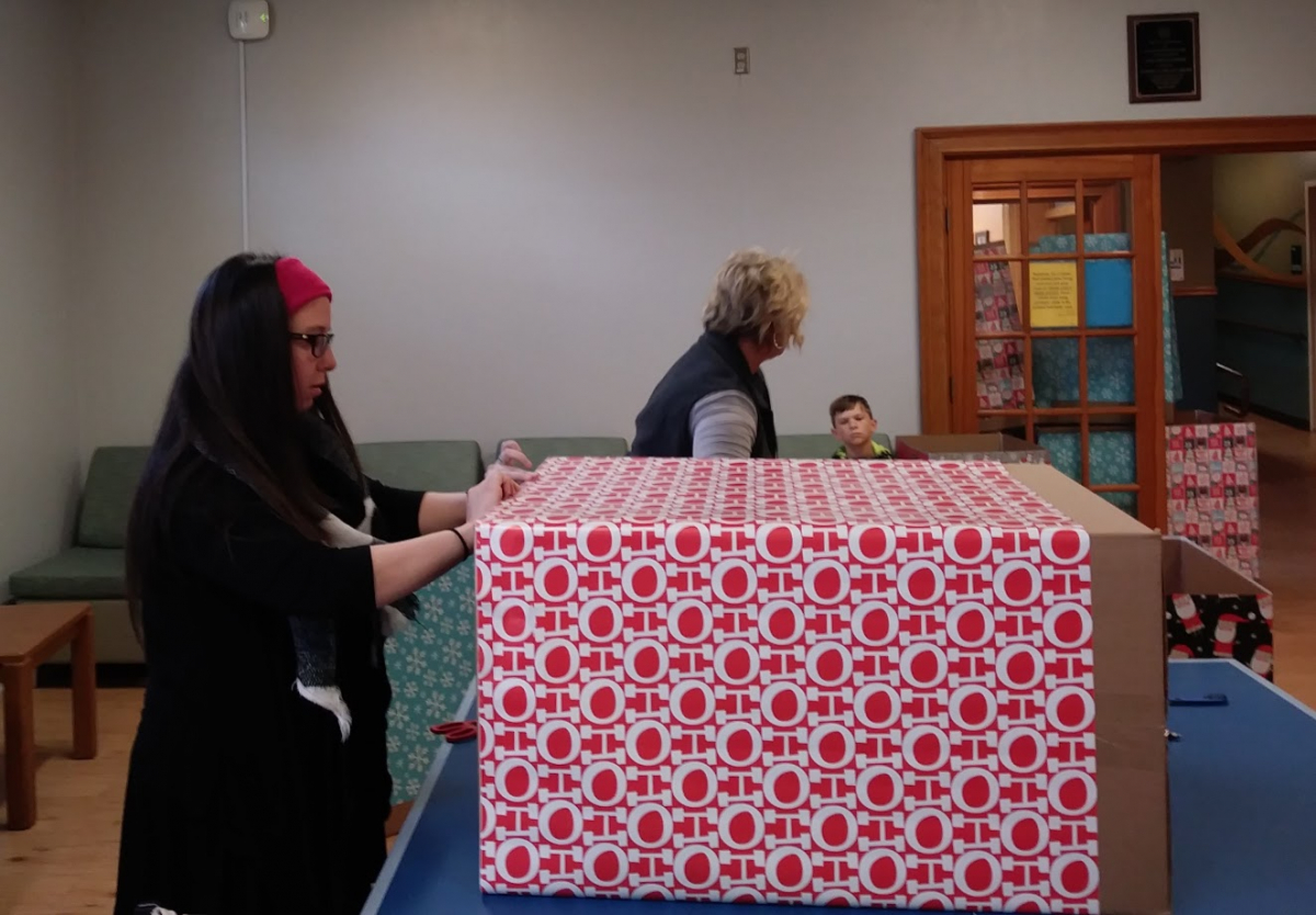 Picture of Staff Senator wrapping present